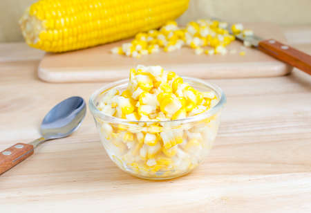 Sweet corn in bowl on wooden tableの写真素材