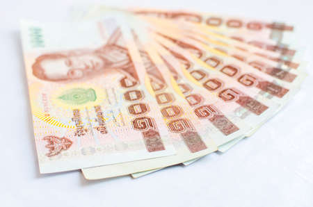 Close up of one thousand Thailand bath banknotes on white background