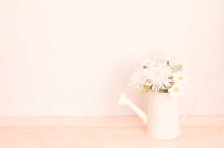 Artificial carnation flower in old watering can with soft vintage colorの写真素材