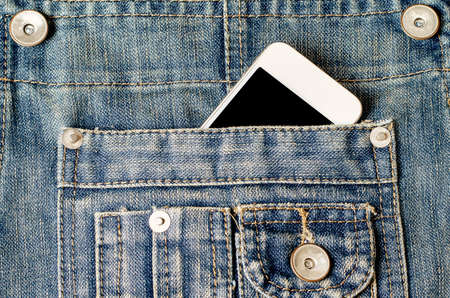 Smart Phone with black screen in jeans pocket - Vintage toneの写真素材