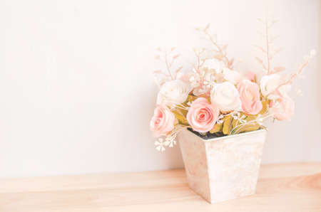 Pastel Coloured Artificial Pink Rose Wedding Bridal Bouquet in flower pot with soft vintage toneの写真素材