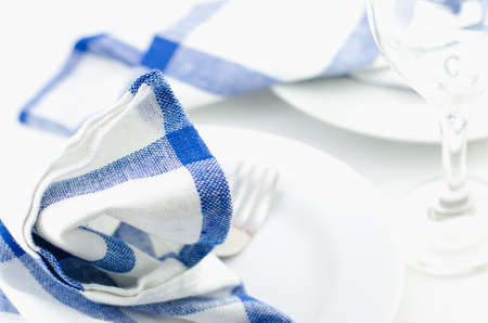 Close up of blue napkin at white plate - table set, dinner timeの写真素材