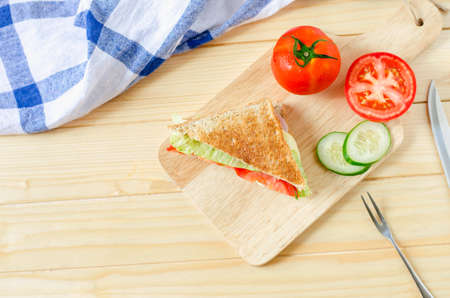 Top view of Healthy Sandwich with cucumber and tomato on wooden boardの写真素材