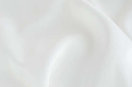 Crumpled of white satin textile backgroundの写真素材