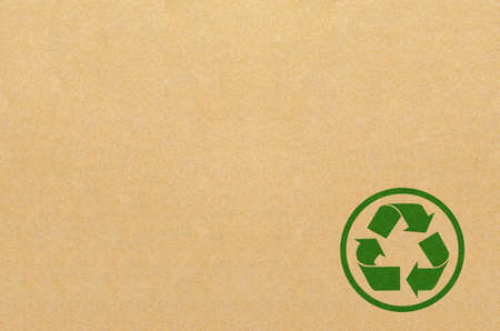 Green recycle symbol painted on brown box texture background,