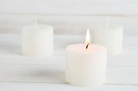 Spa candles burning on white vintage wooden backgroundの写真素材