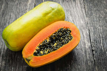 Slice of ripe papayas on wooden table with vintage and vignette, Healthy fruitの写真素材