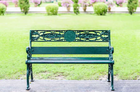 Green Stainless Steel bench on park garden backgroundの写真素材