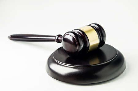 Close up of wooden gavel and soundboard on white backgroundの写真素材