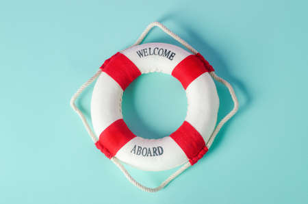 Small red and white lifebuoy on blue backgroundの写真素材