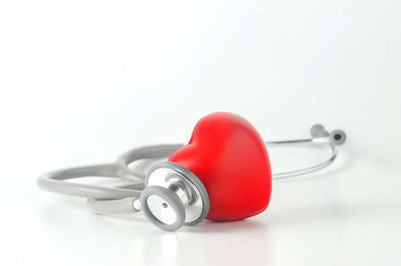 Close up of stethoscope with red heart on white backgroundの写真素材