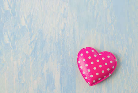 Close up of Pink retro heart with white polka dot pattern on blue vintage wooden background - Valentine backgroundの写真素材