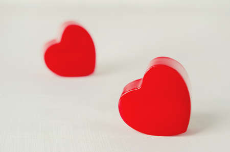 Close up of couple red heart on white wooden background with vintage tone - Valentine backgroundの写真素材