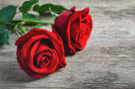 Close up of red rose flower bouquet on old woodenの写真素材
