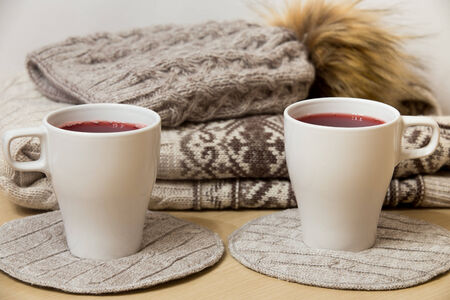 Woolen sweater, knitted hat and two caps of mulled wineの写真素材