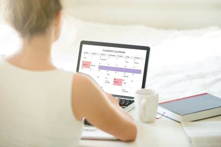 Young business or student woman working at home using laptop, looking at screen with online...