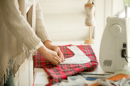 Woman working with a sewing design pattern. Concept photo