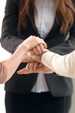 Successful team management, motivated business people forming spirit to unite, employees putting...