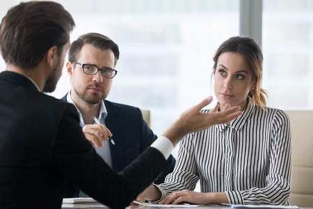 Suspicious recruiters dislike self-confident male job candidate talk at interview, man applicant or employee make bad first impression on HR managers at hiring, failing employment processの写真素材
