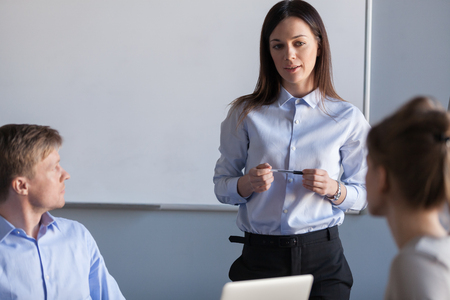 Female team leader focused on discussing new project at group meeting talking to colleagues, woman ceo planning work brainstorming listening to employees ideas, teamwork creative discussion conceptの写真素材