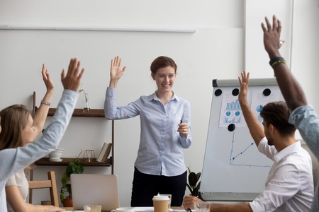 Businesspeople voting raise their hands think the same way, unanimously. Diverse multi-ethnic...