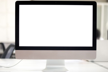 White mock up empty computer monitor screen on desk in office, blank mockup display at workplace, copyspace background for business work, software applications, advertising, websiteの写真素材