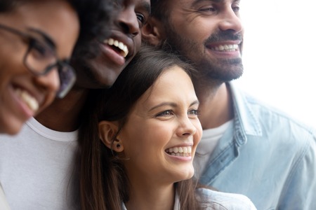 Happy smiling multiethnic friends having fun together close up, diverse multiracial young people, colleagues, students posing for photo, embracing, multiracial friendship conceptの写真素材