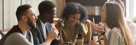 Five friends drinking coffee eating pizza at cafe, diverse people laughing tell jokes having fun in public place, multiracial friendship free time concept, horizontal banner for website header designの写真素材