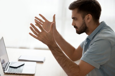 Angry annoyed young man mad about computer online problem, bad news or pc error, furious male user...