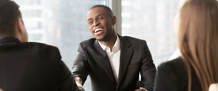 Horizontal photo african applicant feels happy get position, boss congratulate new employee, business partners handshaking. Hr signing contract make good deal concept, banner for website header designの写真素材