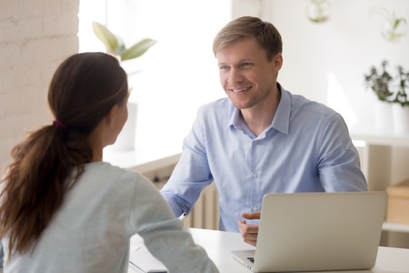 Cheerful man and woman at business meeting. Insurance agent, financial advisor, real estate agent, bank worker interview with client. Startup investor business meeting concept. Successful negotiationsの写真素材