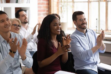 Multiracial happy african and caucasian business team audience people applaud thank for workshop...