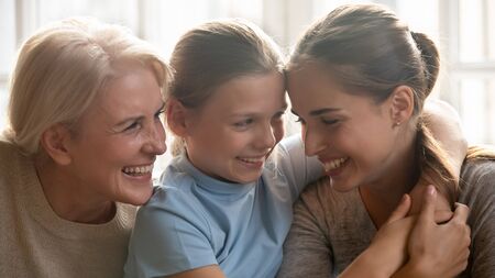 Close up beautiful family portrait 3 women, cheerful three different generation of females gen Z,...