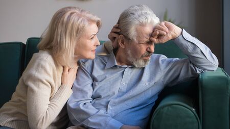 Caring senior wife comfort sad grey-haired elderly husband making peace, reconcile after fight,...