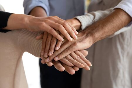 Business people group stacking hands together in pile building strong reliable responsible dream...