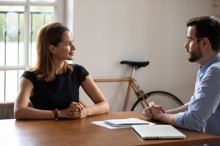 Pleasant young business woman meeting skilled professional lawyer financial advisor at office....