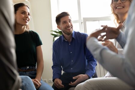 Diverse people attending at group therapy session listening psychologist counsellor, sharing personal stories, supporting overcome struggle with addiction together, psychotherapy meeting rehab conceptの写真素材