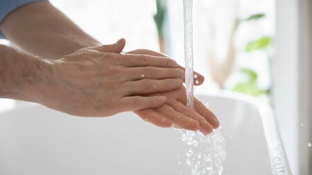 Close up of man clean wash hands with antibacterial soap protect from covid-19 coronavirus outbreak, healthy person take care of hygiene, use sanitizing liquid, stop corona virus pandemicの写真素材