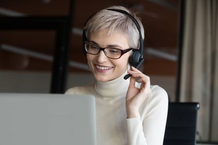 Head shot motivated successful happy 30s female company employee boss leader in eyeglasses wearing...
