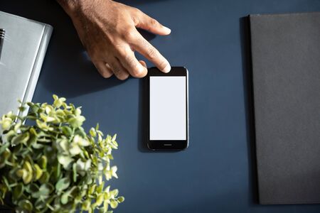 Close up top view of male hand using modern smartphone gadget with touchscreen, cellphone device and...