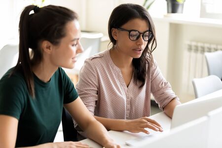 Young serious african american businesswoman with glasses presentation project using laptop for...