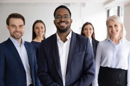 Diverse professionals bank employees company staff members in formal wear, 5 businesspeople lead by African ethnicity leader posing standing together in office. Young aged specialists portrait conceptの写真素材