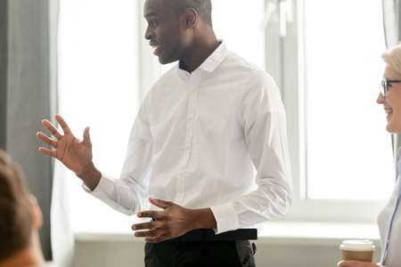 African American businessman team leader holding briefing with employees, black executive manager...