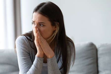 Head shot unhappy young woman looking away, feeling doubtful confused about difficult decision....