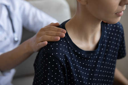 Close up crop of woman doctor or nurse touch support sick hairless female patient struggling...