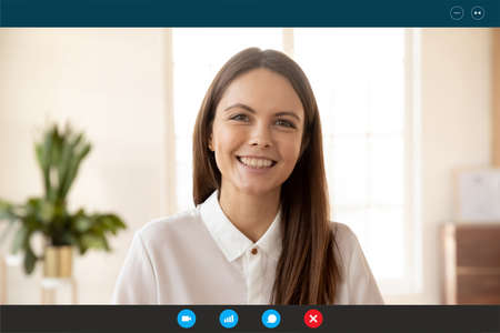 Head shot portrait screen view smiling confident businesswoman using webcam, making video call,...