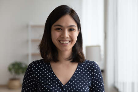 Profile picture of smiling young Vietnamese woman show optimism leadership.の写真素材