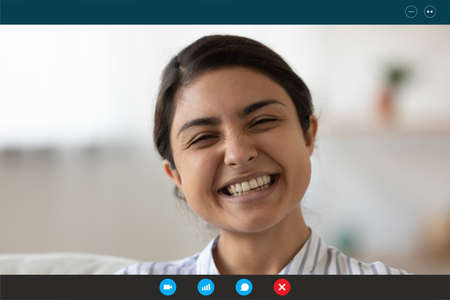 Close up head shot positive young indian ethnicity mixed race woman involved in funny distant video...