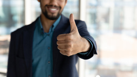 Crop close up of smiling African American businessman show thumb up recommend good quality service....