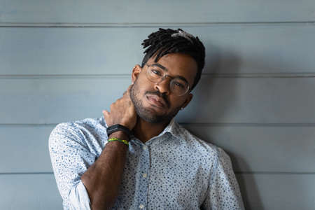 Sharp look. Headshot portrait of handsome bearded modern day young man of african ethnicity wear...